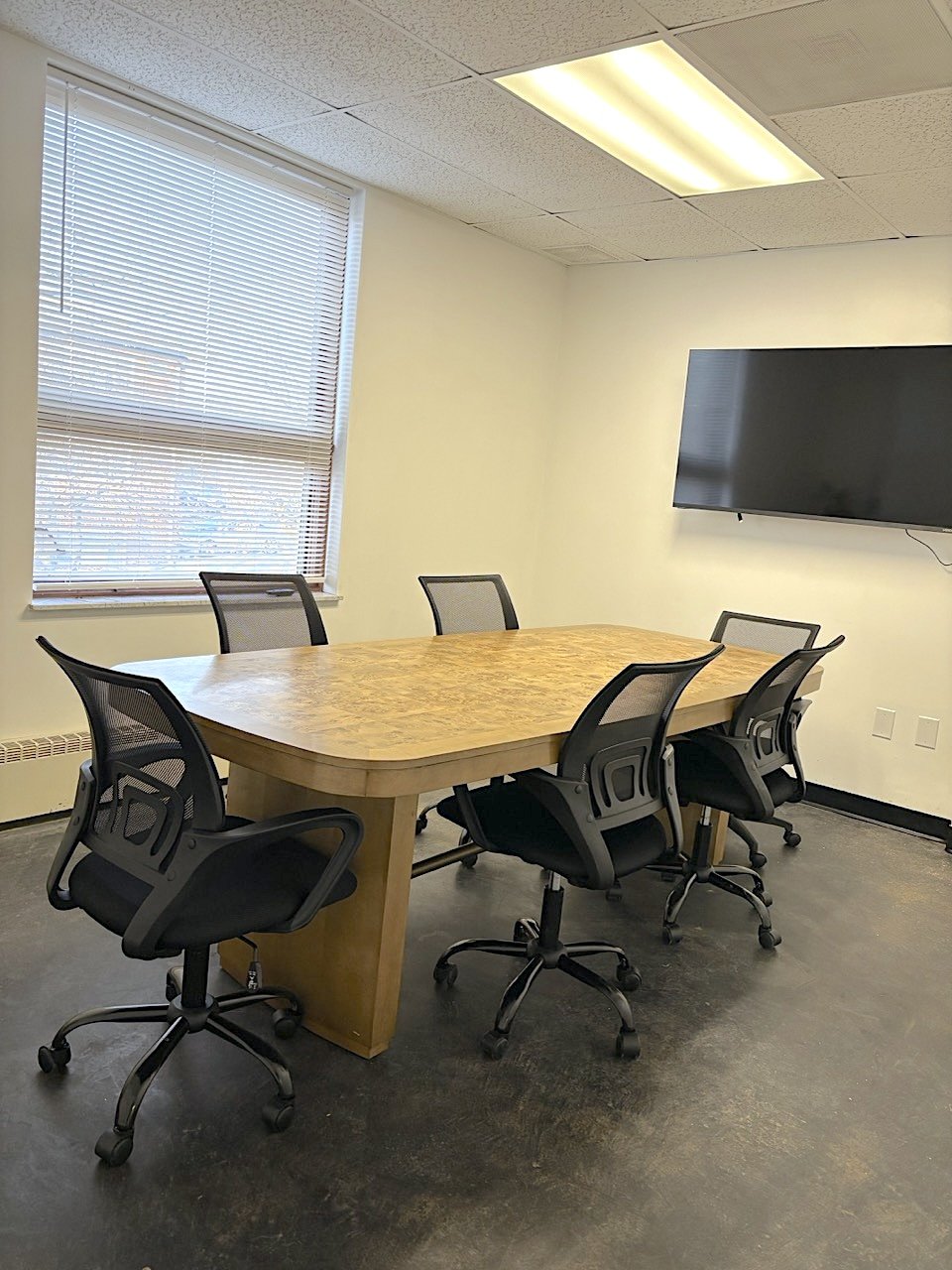 AI Lab Coworking conference room with burl wood table and ergonomic chairs