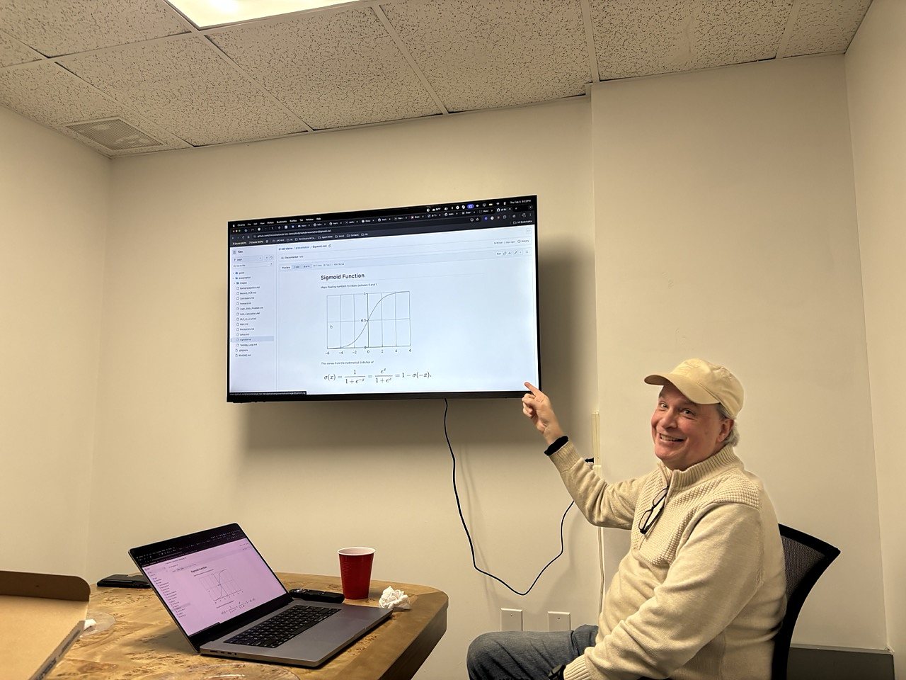 A speaker explaining a neural network slide at the February meetup