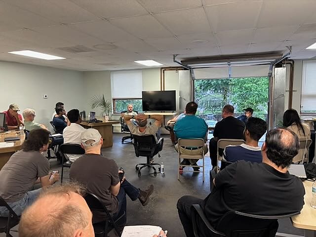 A full room of about twenty people at the May AI Builders Meetup