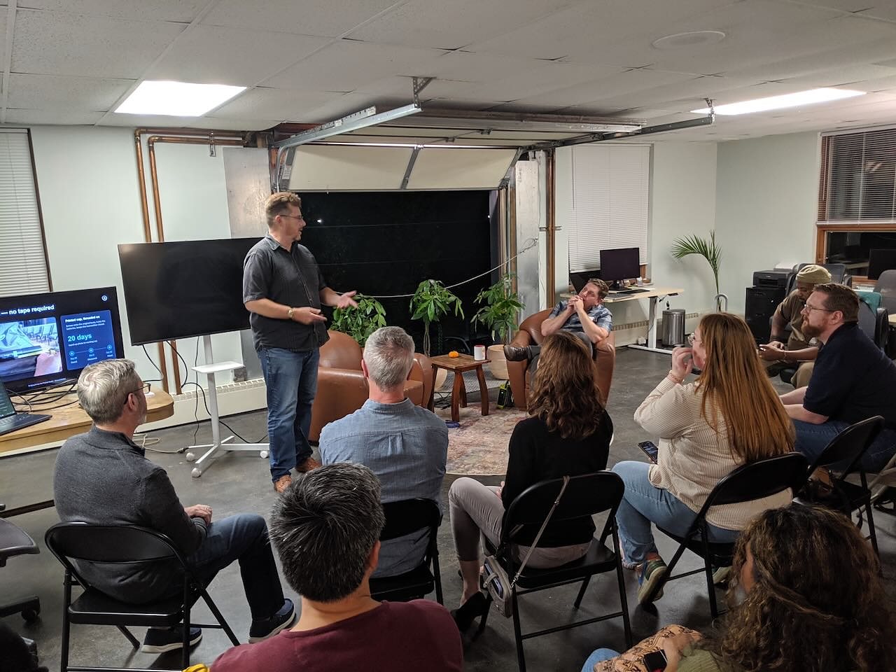 About a dozen people seated for a talk in the event space at the October meetup