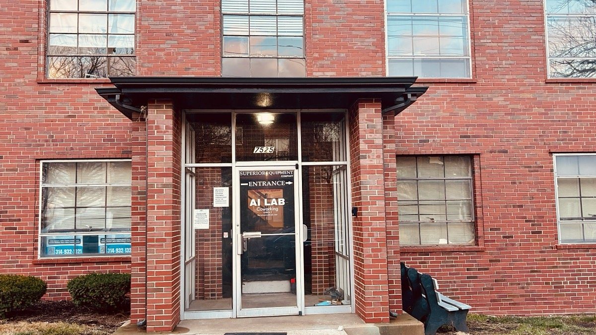 Brick entrance of the building at 7525 Sussex Ave with the AI Lab door